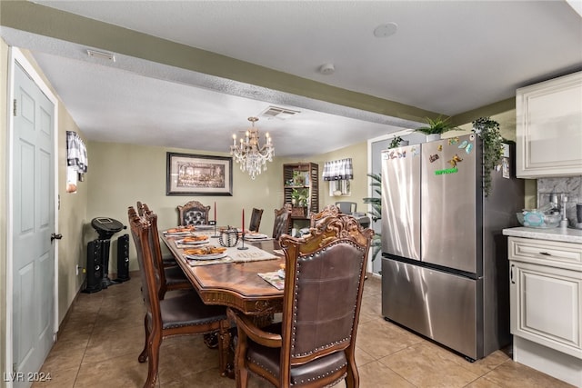 dining space with visible vents, an inviting chandelier, and light tile patterned flooring