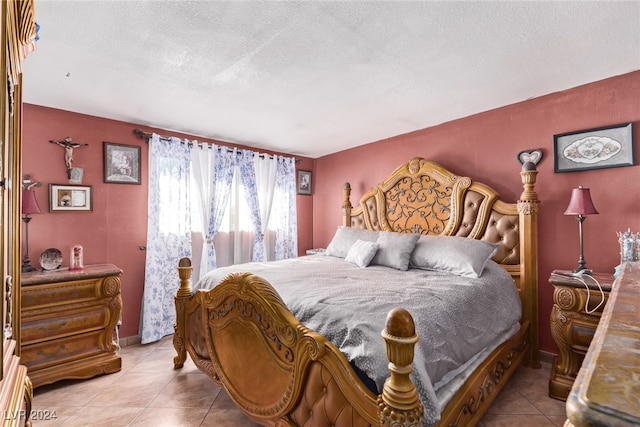 bedroom featuring tile patterned floors and a textured ceiling