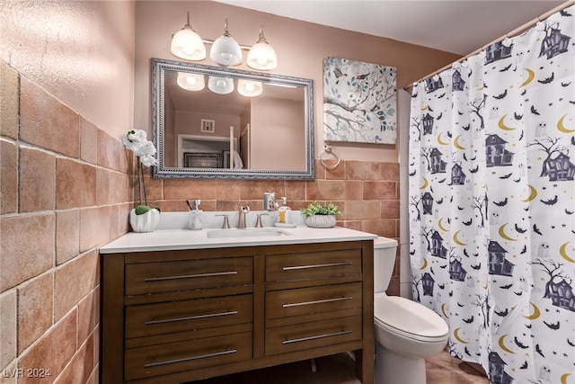 full bath featuring vanity, a shower with shower curtain, visible vents, tile walls, and toilet