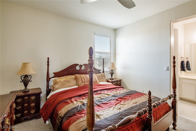 bedroom featuring ceiling fan, light colored carpet, and connected bathroom