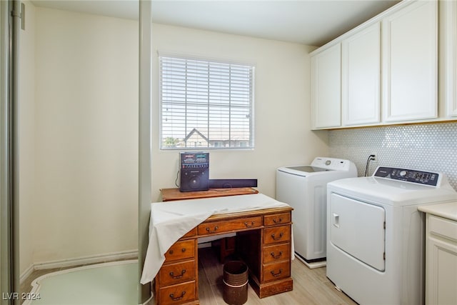 washroom with washer and clothes dryer, cabinets, and light wood-type flooring