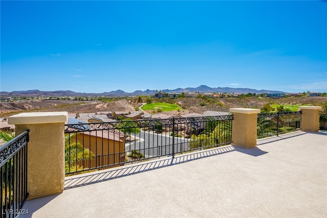 view of patio with a mountain view and a balcony