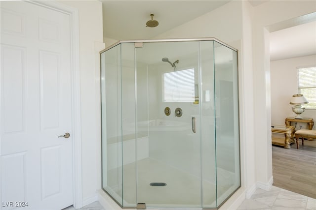 bathroom featuring hardwood / wood-style floors and an enclosed shower