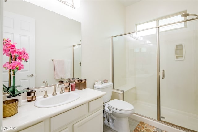 bathroom featuring vanity, toilet, and walk in shower