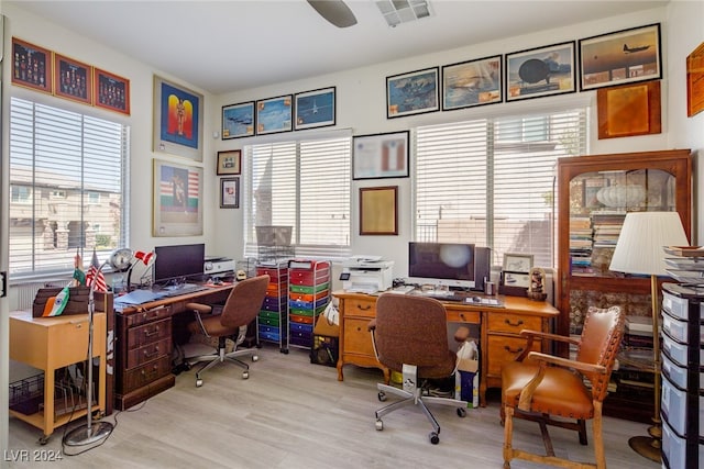 office area with light hardwood / wood-style flooring, a wealth of natural light, and ceiling fan