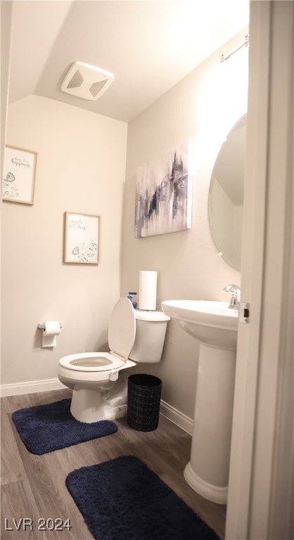 bathroom featuring toilet and wood-type flooring