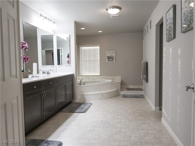 bathroom featuring a relaxing tiled tub and vanity