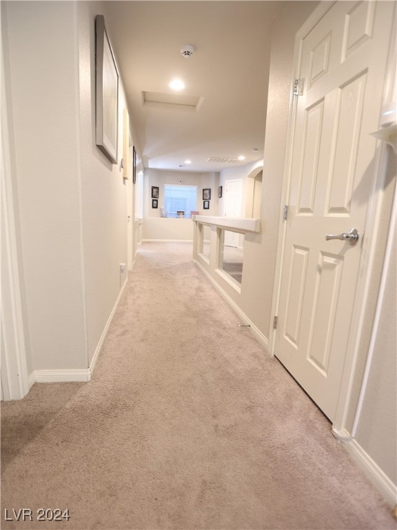 hallway with light colored carpet