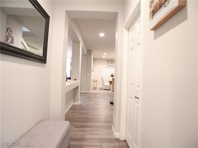 hallway with light hardwood / wood-style floors