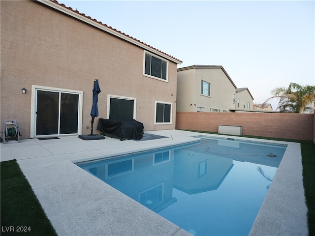 view of pool with area for grilling and a patio area