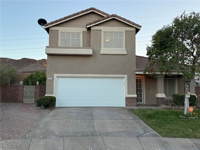 view of front of property with a mountain view and a garage