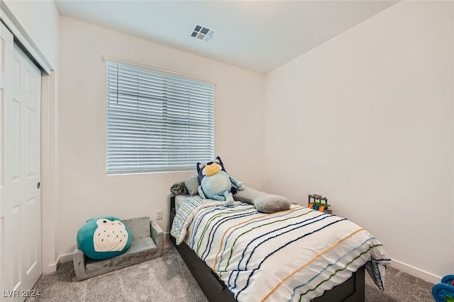 carpeted bedroom with a closet