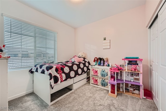 bedroom featuring light carpet and a closet