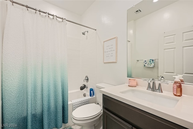 full bathroom with vanity, shower / bath combo, and toilet