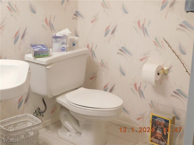 bathroom with tile patterned flooring and toilet