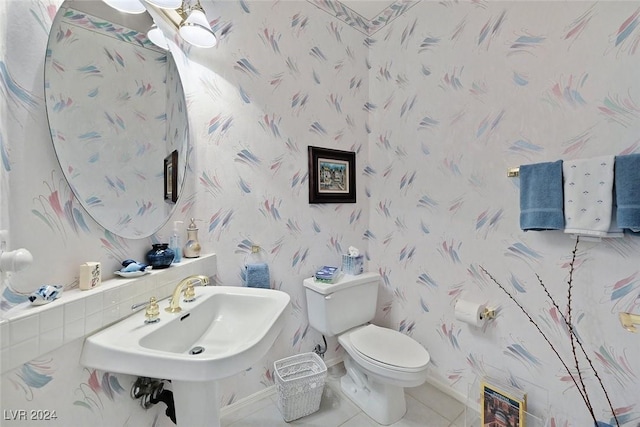 bathroom featuring tile patterned flooring, toilet, and sink