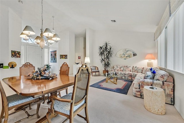 carpeted dining area with a notable chandelier