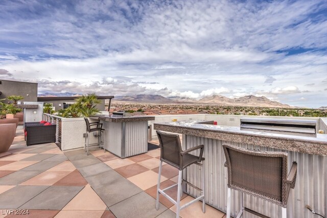 view of patio featuring a mountain view and exterior bar