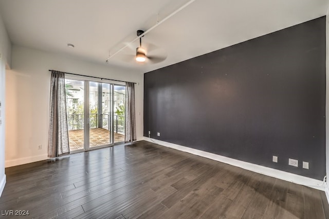 empty room featuring ceiling fan and dark hardwood / wood-style floors