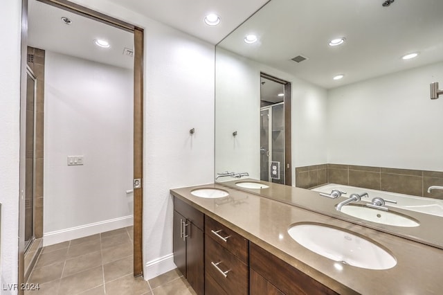 bathroom with tile patterned floors, vanity, and an enclosed shower