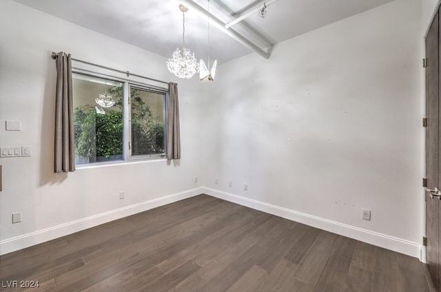 unfurnished room with dark hardwood / wood-style flooring and an inviting chandelier