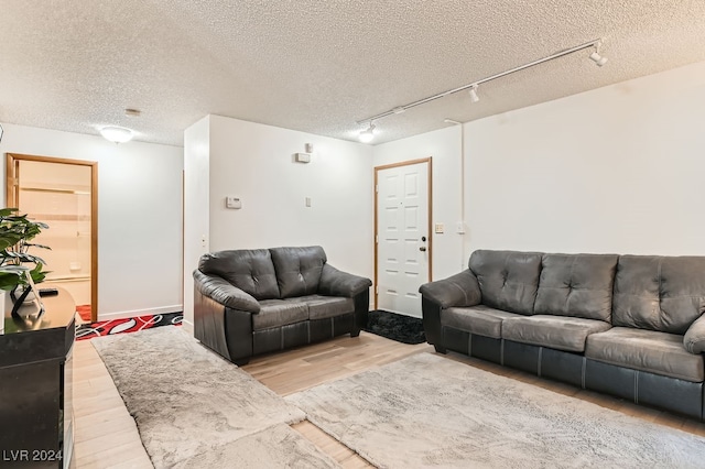 living room with light hardwood / wood-style floors and a textured ceiling