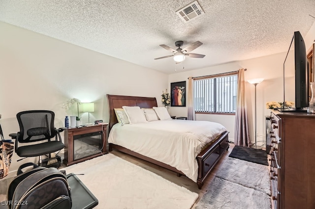 bedroom with a textured ceiling and ceiling fan