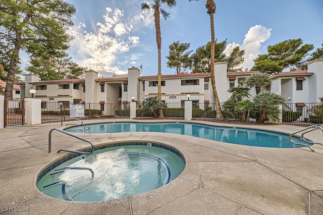 view of swimming pool featuring a community hot tub