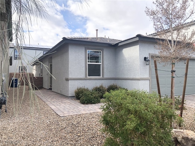 back of house with a garage