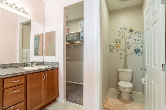 bathroom with tile patterned floors, vanity, and toilet