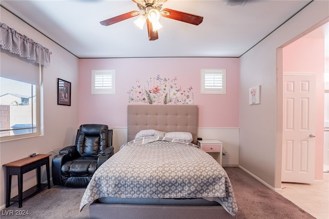 bedroom featuring light colored carpet and ceiling fan