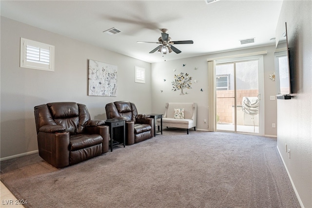 living area with carpet flooring and ceiling fan