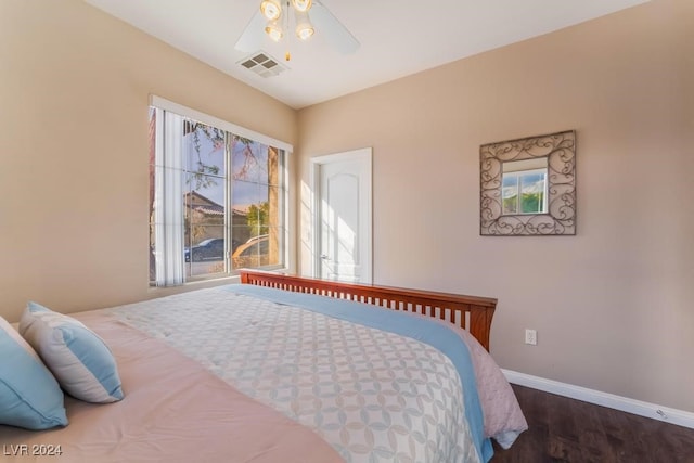 bedroom with dark wood-type flooring and ceiling fan