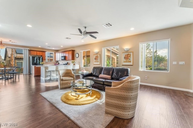 living room featuring dark hardwood / wood-style floors and ceiling fan