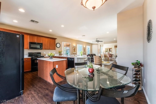 dining area with ceiling fan and dark hardwood / wood-style flooring