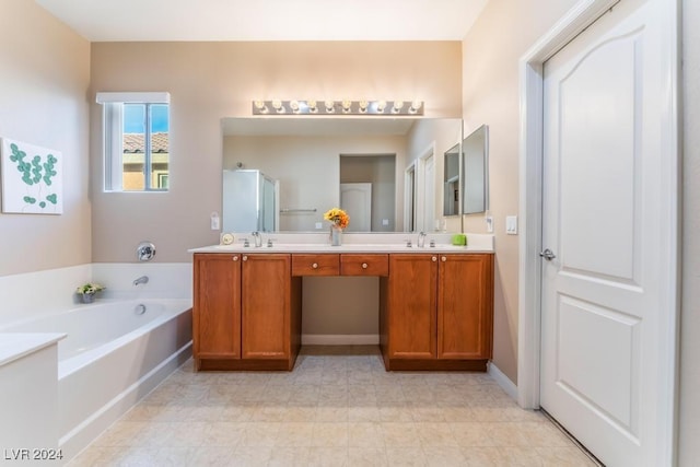 bathroom featuring vanity and independent shower and bath