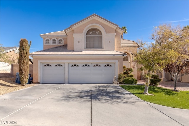 view of front of home featuring a front yard and a garage