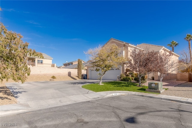 view of front of home featuring a garage and a front yard