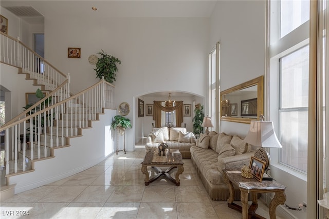 living room with a high ceiling and a notable chandelier