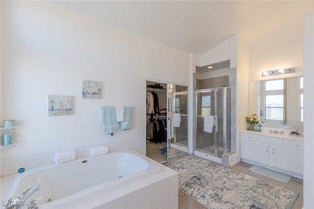 bathroom with shower with separate bathtub, vanity, and vaulted ceiling