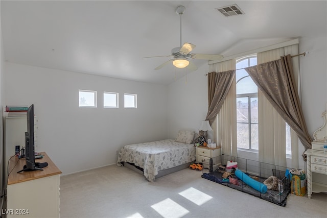 bedroom with ceiling fan, lofted ceiling, light carpet, and multiple windows