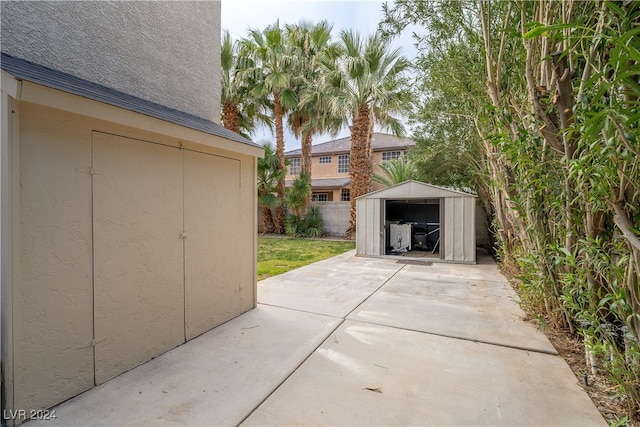 view of patio with a storage unit