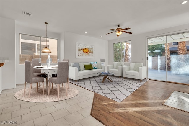 living room featuring ceiling fan and hardwood / wood-style floors