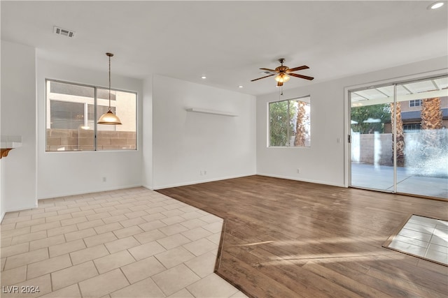 unfurnished living room with light hardwood / wood-style floors and ceiling fan