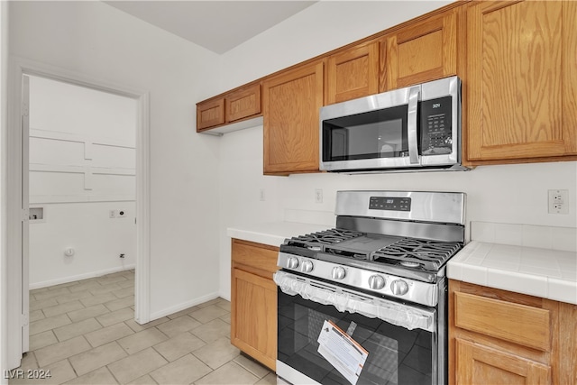 kitchen featuring tile counters and stainless steel appliances