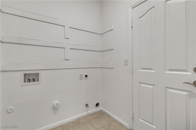 laundry room with hookup for an electric dryer, washer hookup, light tile patterned floors, and hookup for a gas dryer