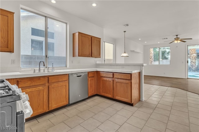 kitchen with ceiling fan, sink, light hardwood / wood-style floors, decorative light fixtures, and appliances with stainless steel finishes