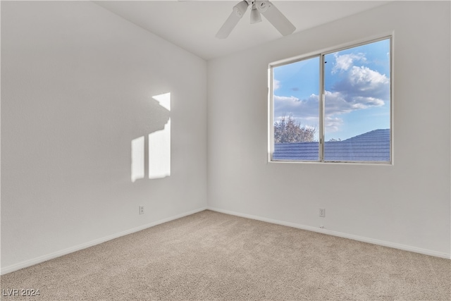 carpeted spare room with ceiling fan