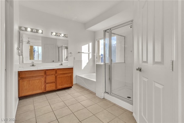 bathroom with tile patterned floors, a wealth of natural light, vanity, and shower with separate bathtub