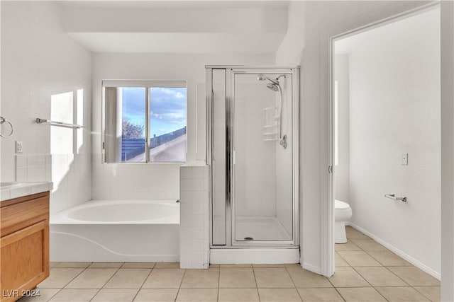 full bathroom with tile patterned floors, vanity, separate shower and tub, and toilet